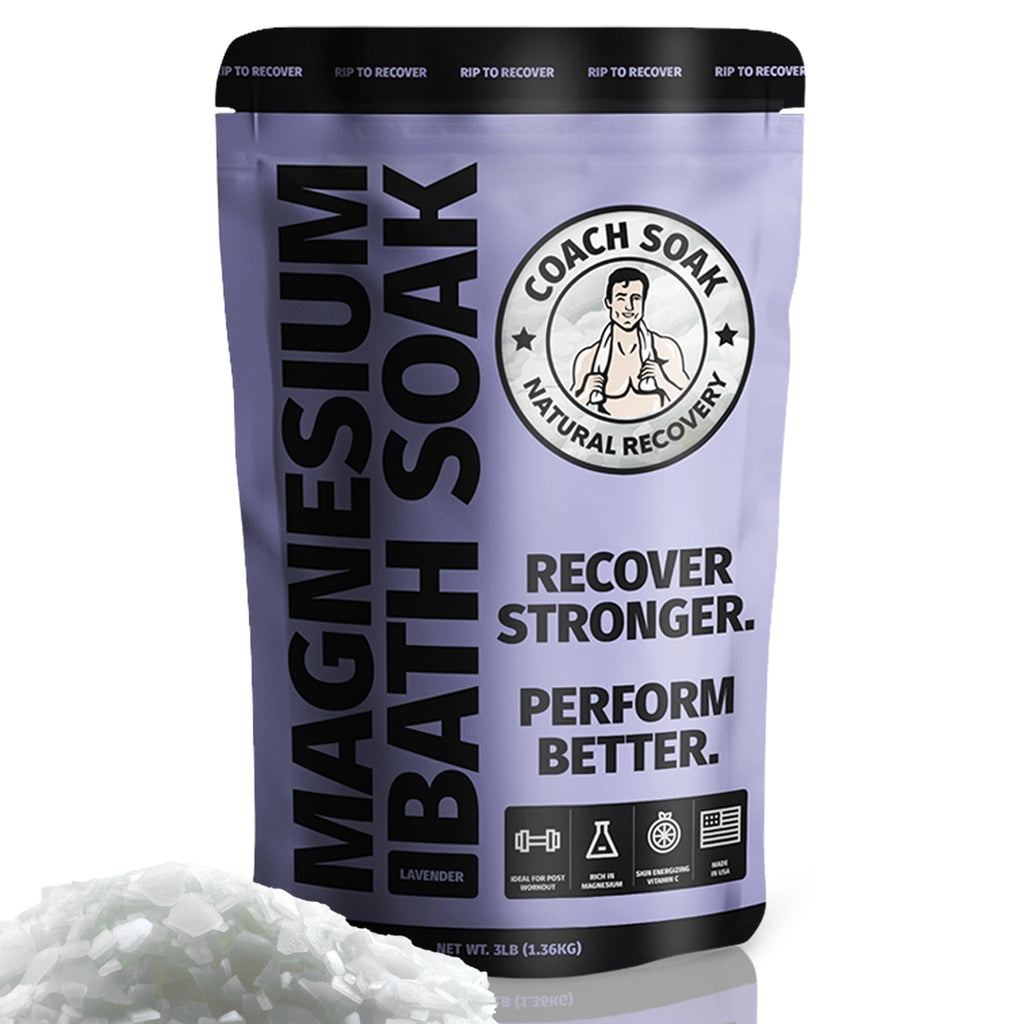 A package of Coach Soak: Muscle Recovery Bath Soak - Dead Sea Bath Salts with a tagline "recover stronger. perform better." in a predominantly purple and white color scheme, indicating a product designed for muscle recovery and athletic performance