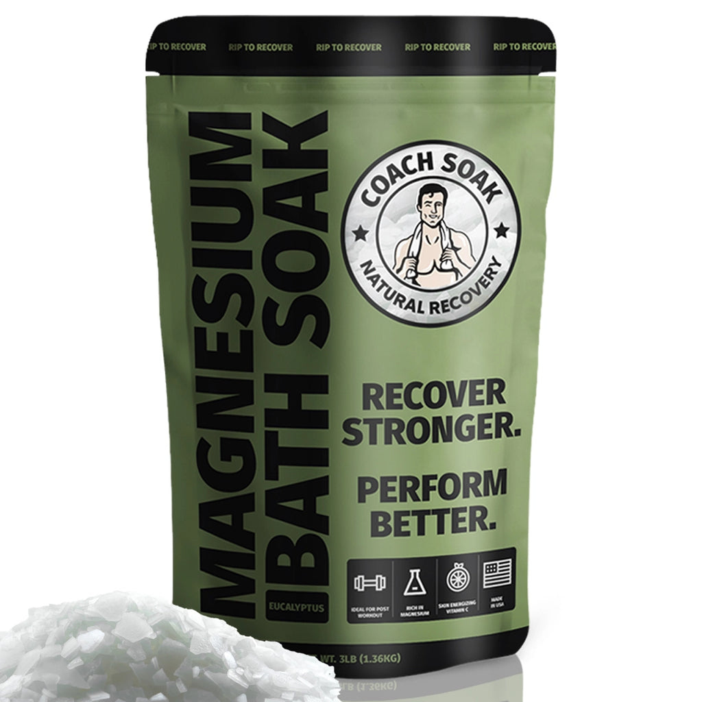 A bag of "Coach Soak: Muscle Recovery Bath Soak - Dead Sea Bath Salts - Absorbs Faster than Epsom Salt" by coach soak with the slogan "recover stronger. perform better." displayed next to a pile of salts, indicating a product designed for