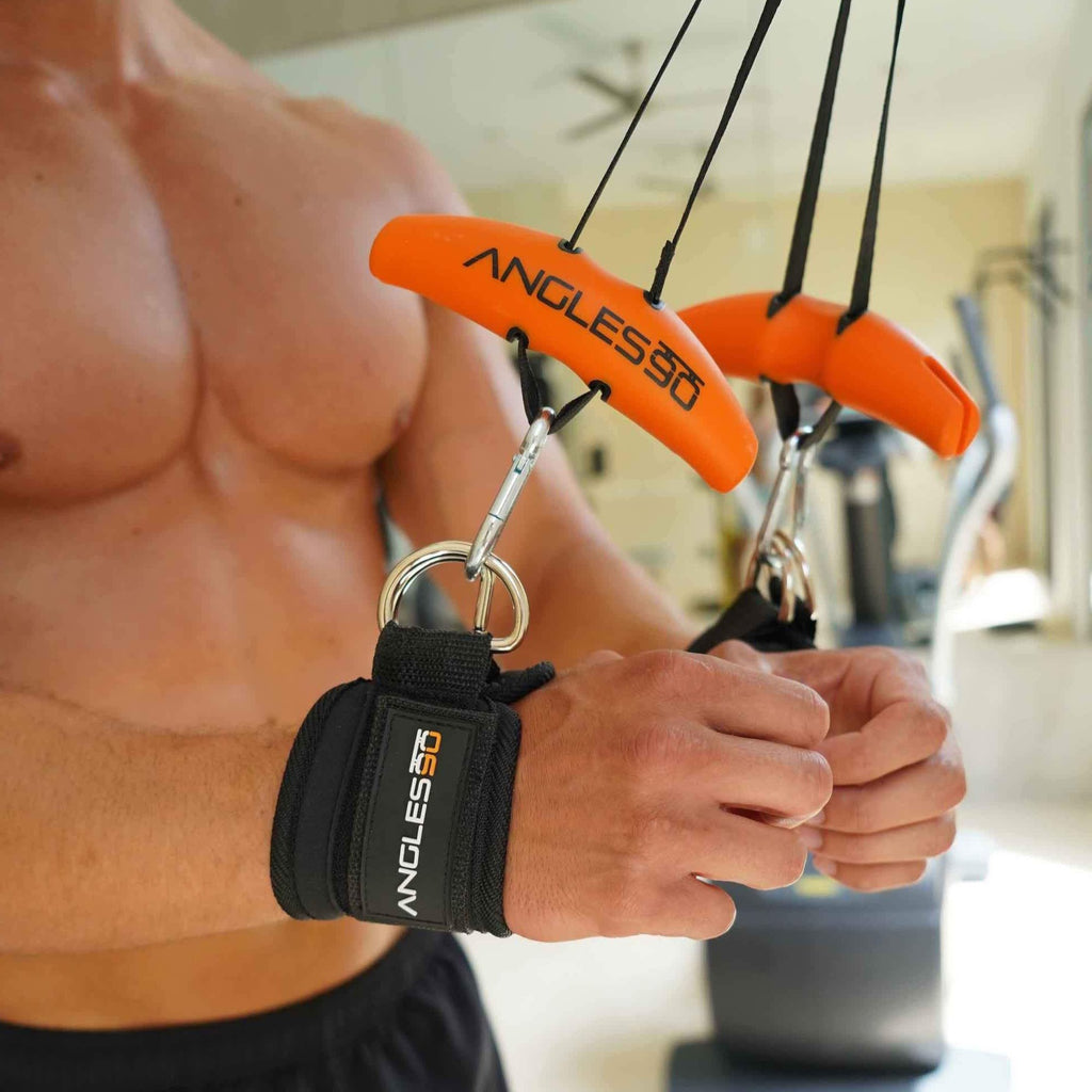 A person with a muscular build is holding workout resistance bands with attached A90 Ankle Straps, ready for exercise session.